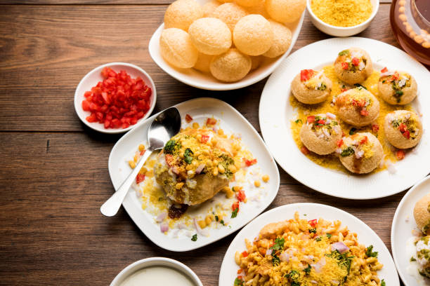 Bombay Chat food in group group of Bombay chat food includes golgappa/panipuri, bhel-puri, sev-poori, dahipuri, Ragda pattice, raj kachori etc. selective focus raj kachori stock pictures, royalty-free photos & images