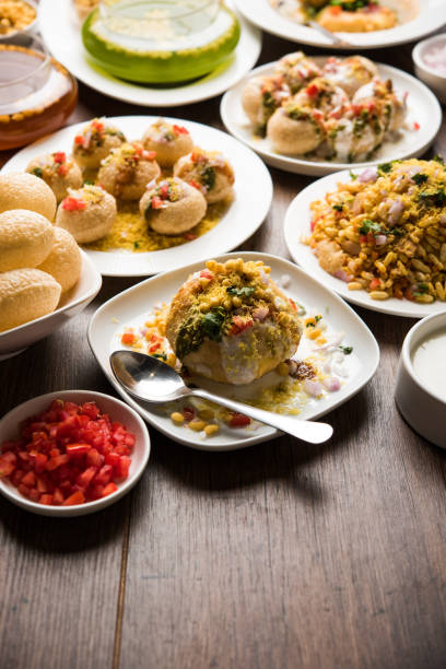 Bombay Chat food in group group of Bombay chat food includes golgappa/panipuri, bhel-puri, sev-poori, dahipuri, Ragda pattice, raj kachori etc. selective focus raj kachori stock pictures, royalty-free photos & images