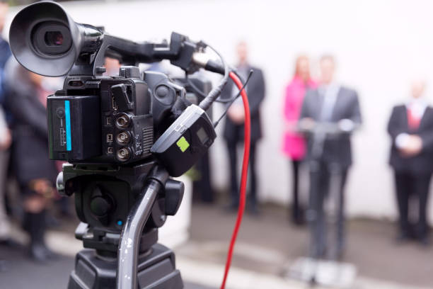 istock Filming news or press conference with a video camera 1155444616
