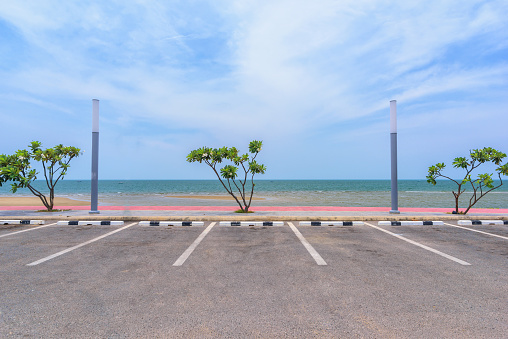 Empty parking lot against sea and beautiful blue sky.