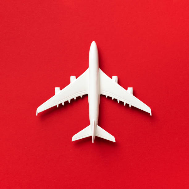 istock Travel, vacation concept. White model airplane on red color background with copy space. Top view. Flat lay. Minimal style design. Square crop 1155445863