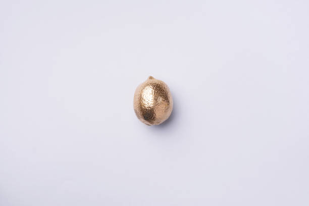 istock Golden lemon on grey background. Creative food concept. Top view. Flat lay. Single exotic gold fruit. 1155445880