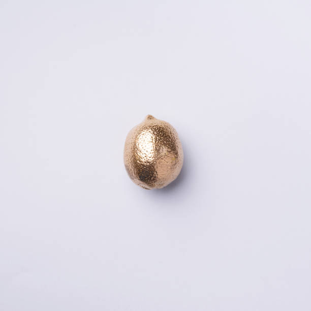 istock Golden lemon on grey background. Creative food concept. Top view. Flat lay. Single exotic gold fruit. 1155445911