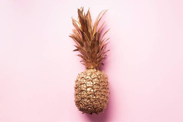 istock Creative layout. Gold pineapple on pink background with copy space. Top view. Tropical flat lay. Exotic food concept, crazy trend 1155446142
