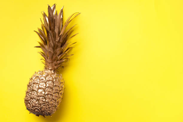 istock Creative layout. Gold pineapple on yellow background with copy space. Top view. Tropical flat lay. Exotic food concept, crazy trend. Banner 1155446148