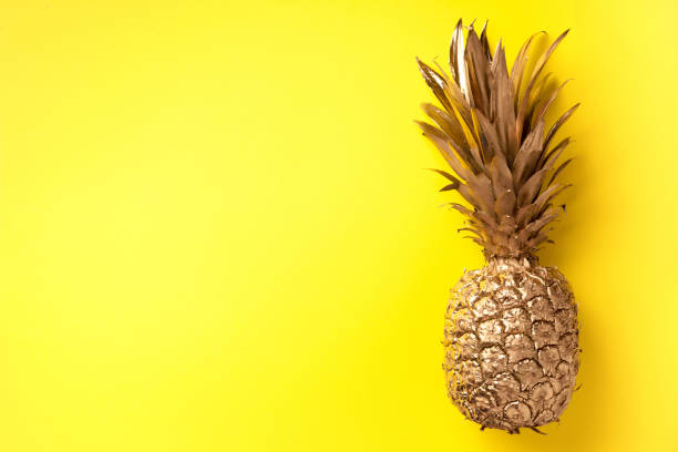 istock Creative layout. Gold pineapple on yellow background with copy space. Top view. Tropical flat lay. Exotic food concept, crazy trend. Banner 1155446149