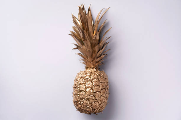 istock Creative layout. Gold pineapple on grey background with copy space. Top view. Tropical flat lay. Exotic food concept, crazy trend. Banner 1155446150