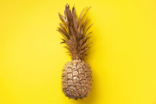 istock Creative layout. Gold pineapple on yellow background with copy space. Top view. Tropical flat lay. Exotic food concept, crazy trend. Banner 1155446155