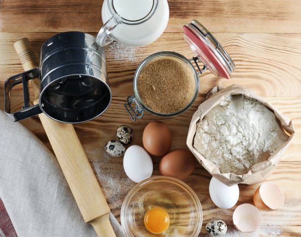 istock Set for baking. In the frame, a jug of milk, flour, sugar, quail eggs and chicken eggs, a rolling pin, a flour sifter. 1155446829
