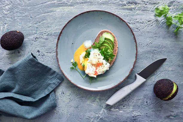istock Avocado sandwich with dark bread, sliced avocado and poached egg 1155447711