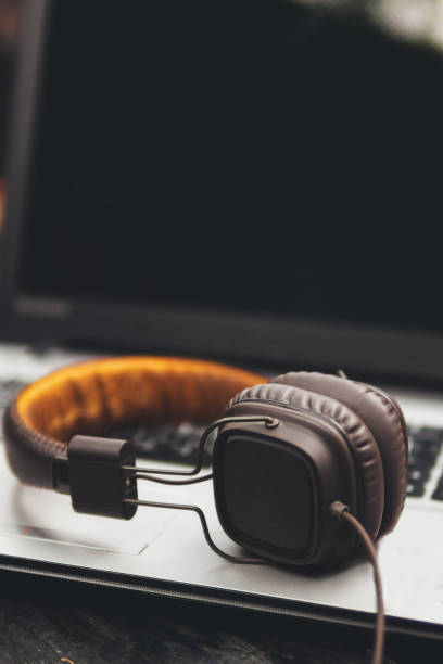 istock Headphones lie next to the laptop on the desktop 1155452449