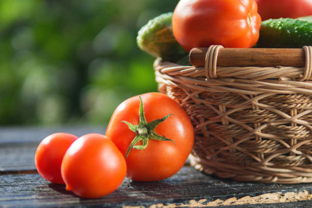 istock Tomatoes and cucumbers in a basket 1155452565