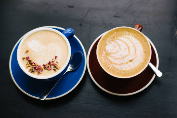 istock Two cups of cappuccino with latte art. 1155454044