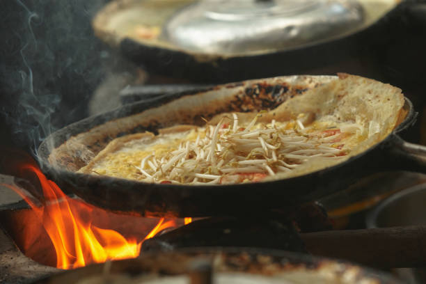 Vietnamese Banh Xeo crepes or vietnamese pancake make from rice flour and filled with a shrimp meat soya bean sprouts is popular Viet Nam street food
