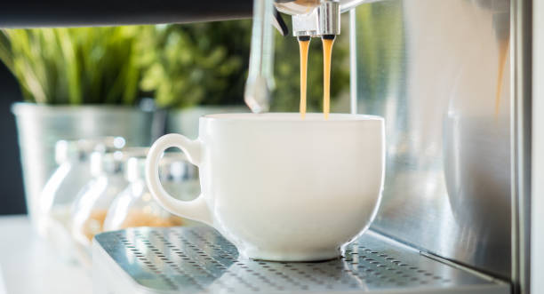 istock coffee machine espresso looking fresh coffee into a neat ceramic cup 1155454301