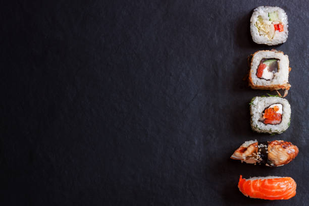 istock Top view traditional japanese sashimi sushi on black board background copy space 1155454789