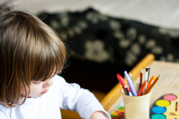 istock Happy little girl drawing at home. 1155456103