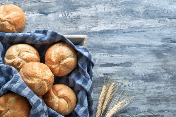 istock Crusty round bread rolls, known as Kaiser or Vienna rolls on linen towel 1155457255