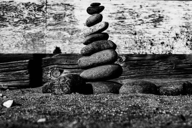pebbles stacked to form a splendid pyramid on the beach of Marbella create an opportunity to meditate and relax with yoga