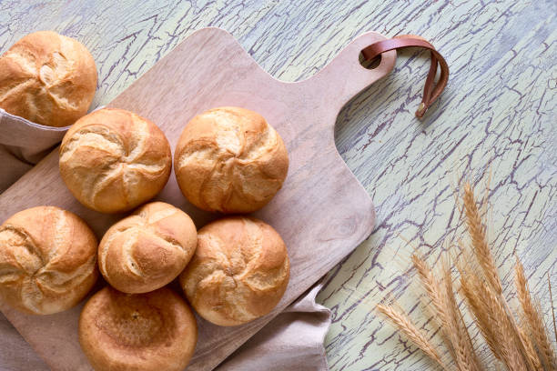 istock Crusty round bread rolls, known as Kaiser or Vienna rolls on linen towel 1155458609