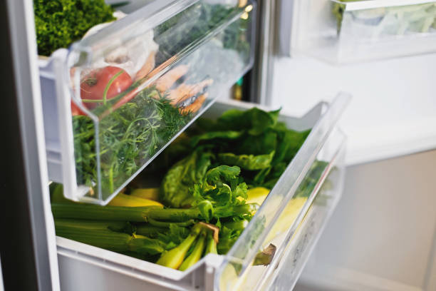 istock Plastic free carrots,tomatoes, mushrooms,bananas,salad, spinach, celery, apples in fridge. Zero waste grocery shopping. Fresh vegetables in opened drawer in refrigerator. Vegetarian diet 1155458803