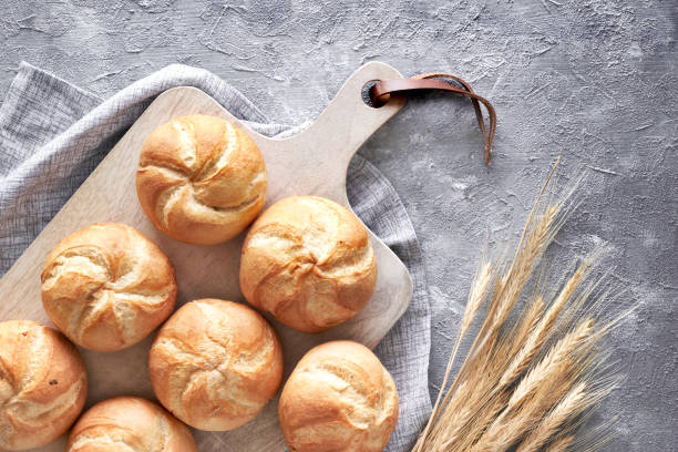 istock Crusty round bread rolls, known as Kaiser or Vienna rolls on linen towel 1155458958