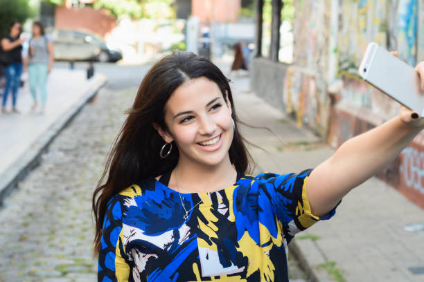 istock Latin woman making selfie. 1155459046