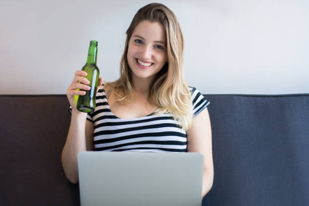 istock Young woman using a laptop computer at home 1155459080