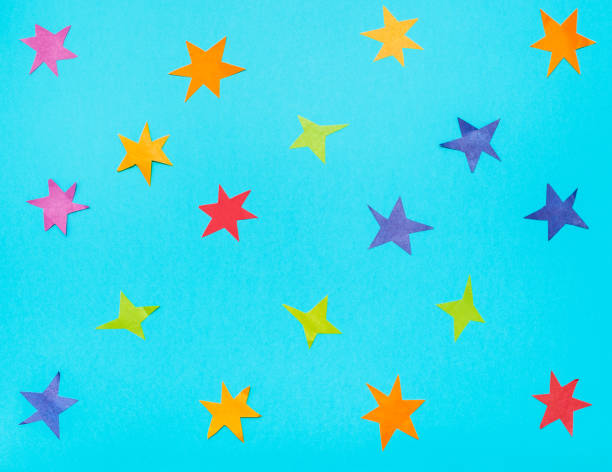istock many stars cut from colour papers on blue paper 1155459633