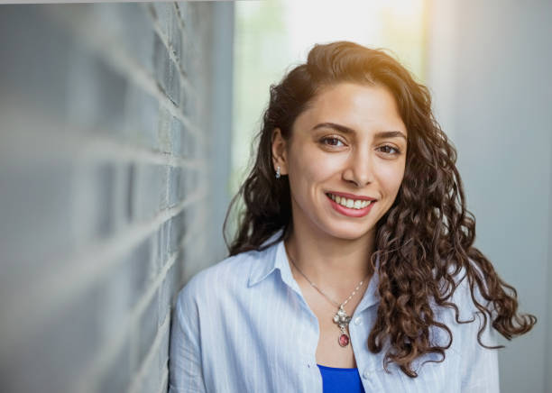 istock Young ethnic female student smiling 1155460568