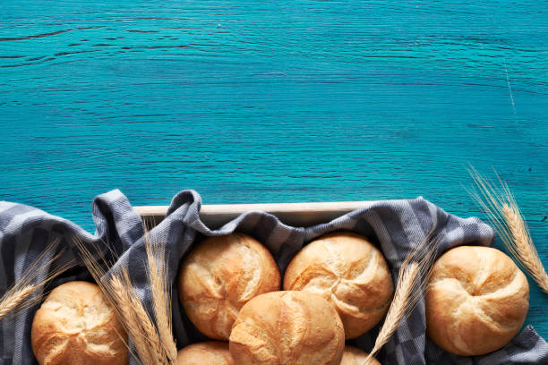 istock Crusty round bread rolls, known as Kaiser or Vienna rolls on linen towel 1155460746
