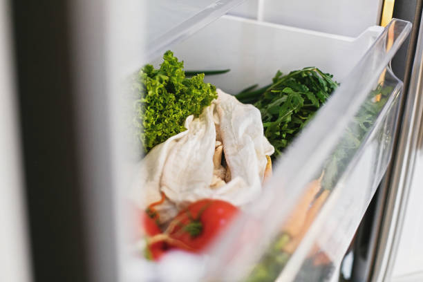 istock Zero waste grocery in fridge. Fresh vegetables in opened drawer in refrigerator. Plastic free carrots,tomatoes, mushrooms,radish,salad, arugula, zero waste shopping concept.Vegetarian diet 1155460830