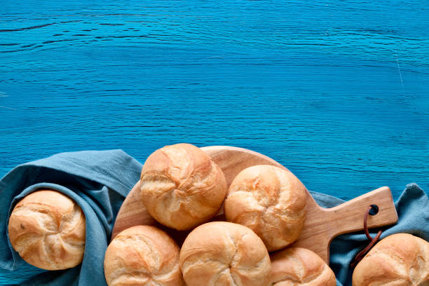 istock Crusty round bread rolls, known as Kaiser or Vienna rolls on linen towel 1155461075