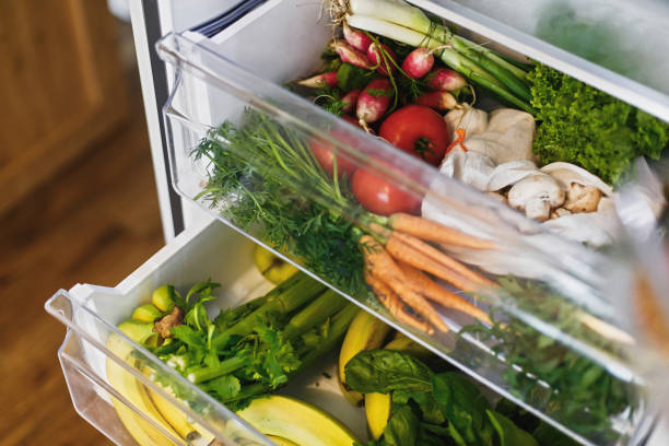 istock Zero waste grocery in fridge. Fresh vegetables in opened drawer in refrigerator. Plastic free carrots,tomatoes, mushrooms,bananas,salad, celery, apples, zero waste shopping. Grocery delivery 1155461253