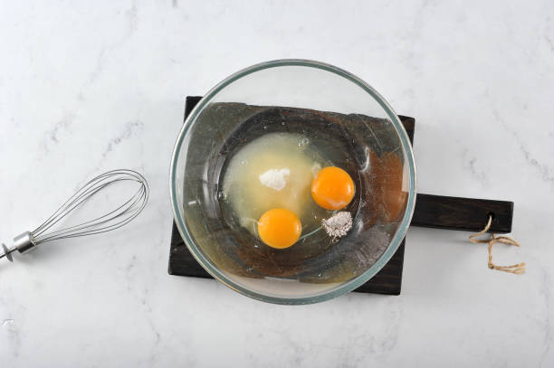 istock In a deep bowl, eggs, sugar, vanillin for biscuit. In the frame, a whisk for knocking. View from above. 1155461514