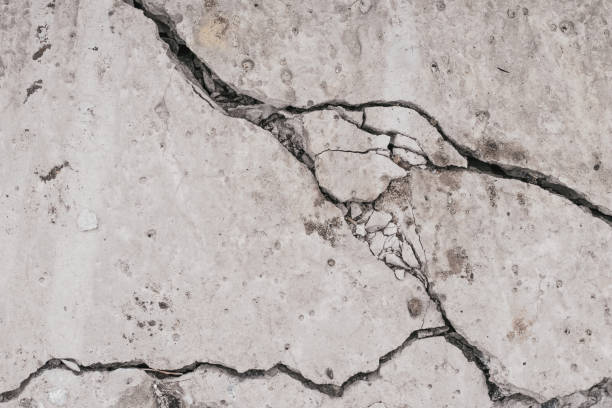 Crack concrete wall. Old dirty cracked wall texture. Gray stone background. Abstract pattern of grunge floor. Messy damage worn of broken building. stock photo