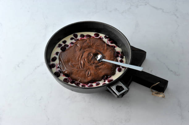 istock Dough in the form for baking. Biscuit-cottage cheese dough and cherry berries on top. Chocolate dough on top. 1155462335