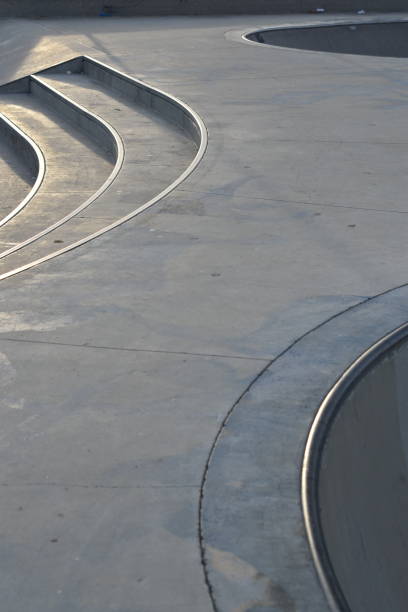 istock Skate Park in Late Afternoon Light Bowls and Stairs vertical 1155462509