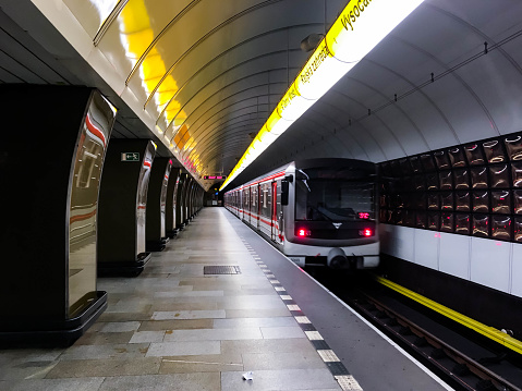London, UK - 25 August, 2022: blurred motion of a subway train as it departs the modern architecture of the newly built Battersea Power Station underground station on the London Underground network.