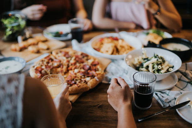 Group of young Asian man and woman having fun and enjoying food and drinks together during party Group of young Asian man and woman having fun and enjoying food and drinks together during party blind date stock pictures, royalty-free photos & images