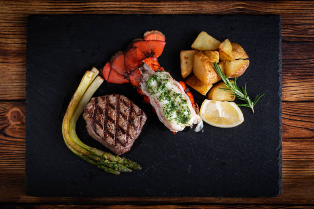 istock surf and turf on black stone plate 1155467245