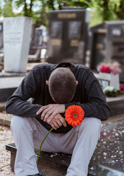 istock Man in the cemetery 1155474959