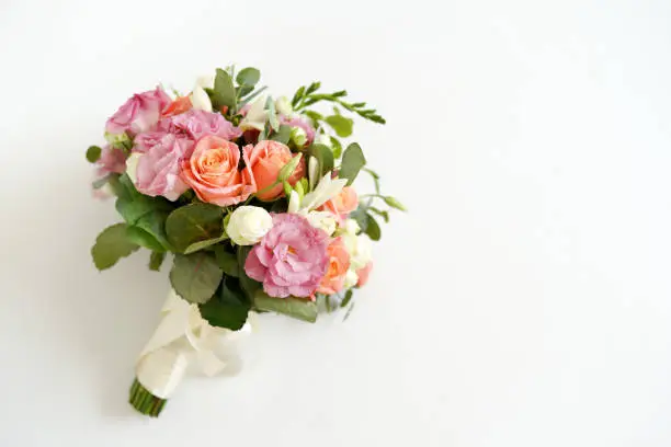 Photo of wedding bouquet with flowers roses on a white background with copy space. minimal concept. mockup