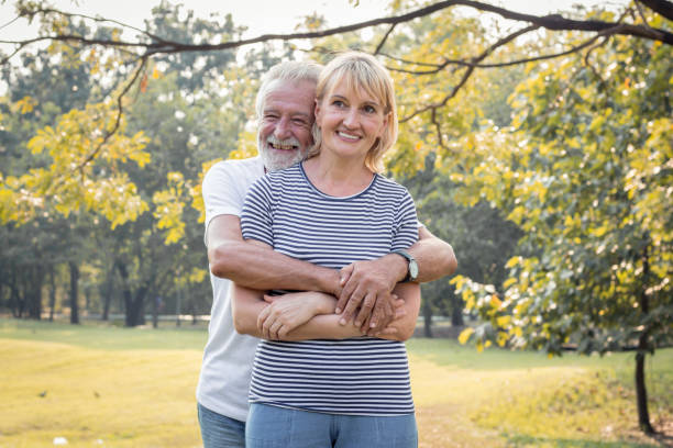 istock Senior couples stand to hug each other and smile happily. 1155479026