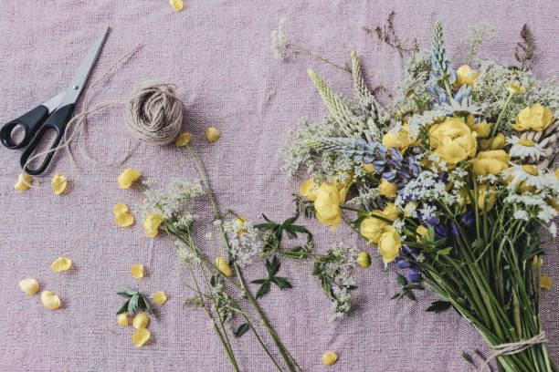 istock wild yellow flower bouquet on pink table cloth 1155480799