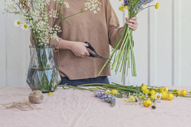 istock woman florist making flower bouquet on table 1155480824