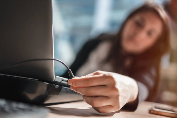istock Business woman charging her laptop 1155482575