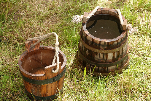 Two wooden water buckets