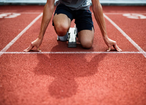 istock Unrecognizable Athlete Preparing For Start On Running Track. 1155484157