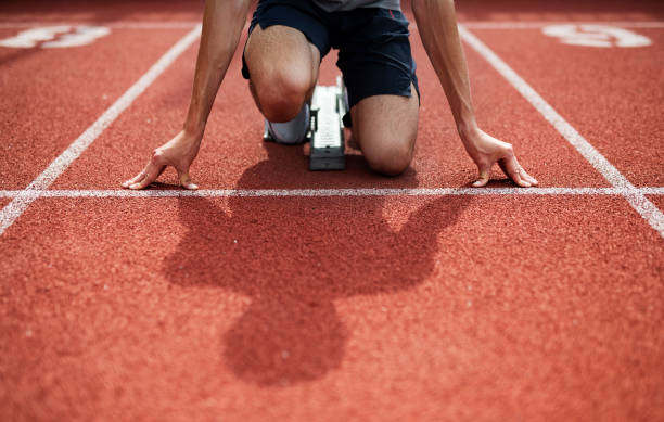 istock Unrecognizable Athlete Preparing For Start On Running Track. 1155484158